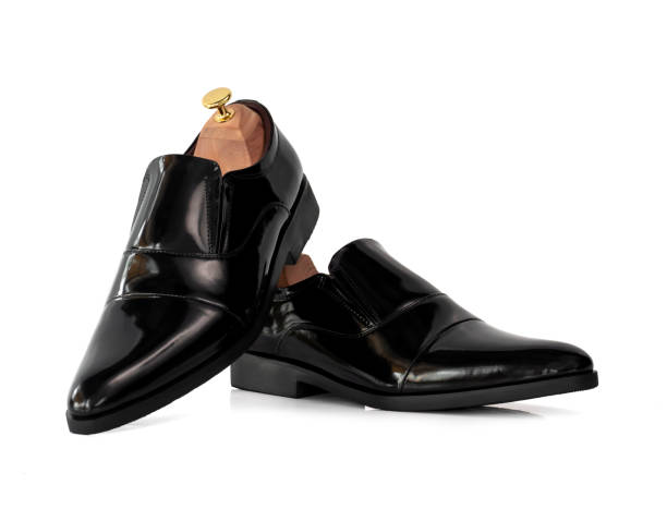 istock Men fashion leather loafer black shoe with shoe tree (shape supporter) isolate on white background. 1277109017