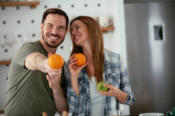 istock Young couple making breakfast at home. 1277109225