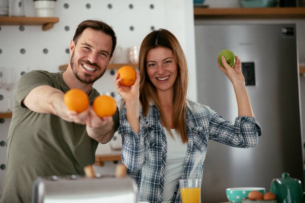 istock Young couple making breakfast at home. 1277109241