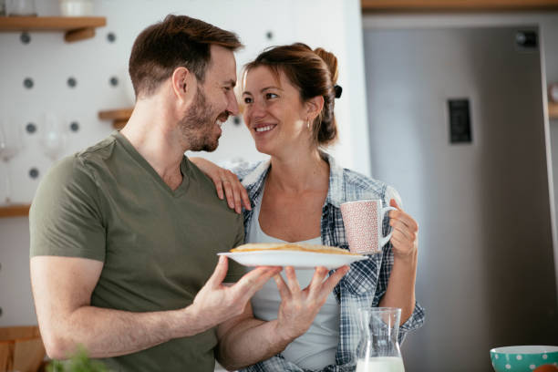 istock Young couple making breakfast at home. 1277109270