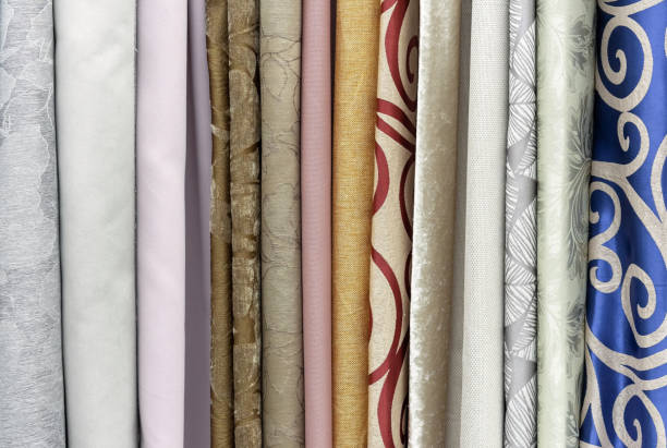 istock Samples of curtain fabrics. Background and texture of curtains. 1277109936