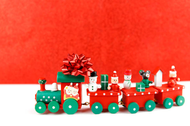 istock Little toy train with christmas figures. Holiday greeting card. 1277110226