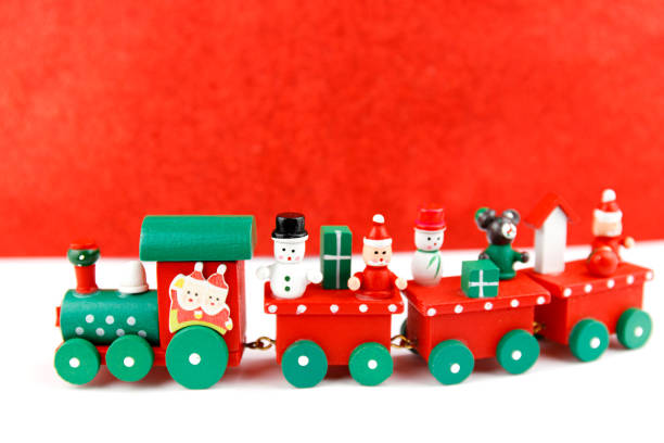 istock Little toy train with christmas figures. Holiday greeting card. 1277110232