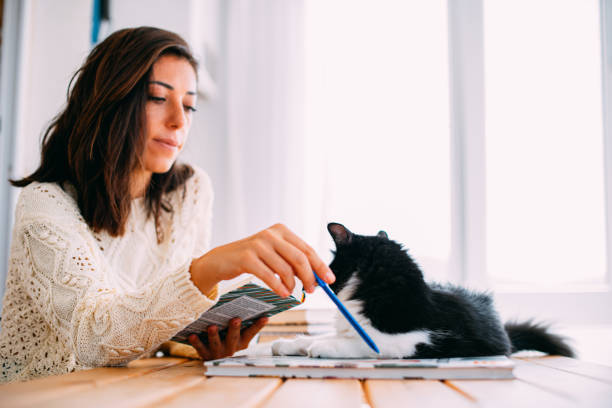 istock Urban Woman Reading a Book With Her Cat 1277110384
