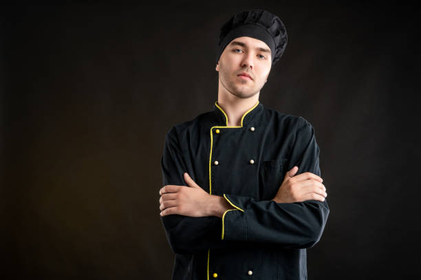 istock Young male dressed in a black chef suit looking confident hiro shot 1277110610