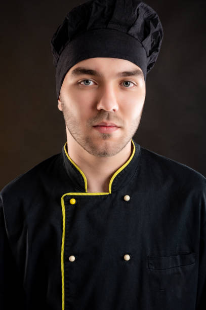 istock Portrait of young male dressed in a black chef suit 1277110730