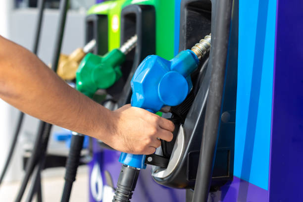 istock hand holding a fuel pump at a gas station 1277112170