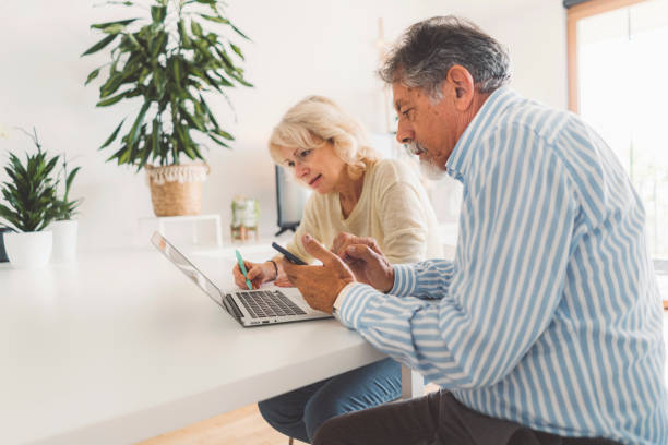 istock Senior couple paying monthly bills at home 1277112342