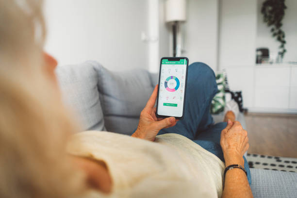 istock Senior woman looking at a graph on savings app on her phone 1277112364