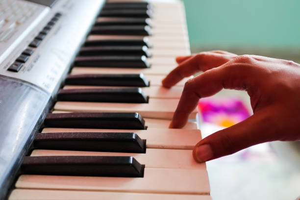istock hands of musician playing piano. view from side. 1277113077