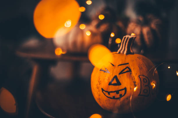 istock Halloween - Jack O' Lanterns - String Lights On Wooden Table 1277113593