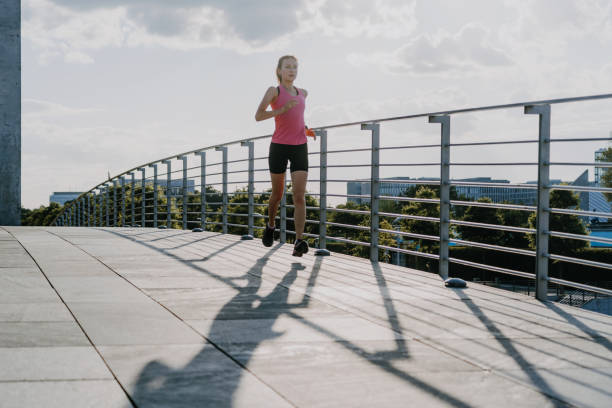 istock woman running in modern business district 1277113632
