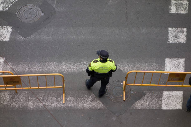 police between two yellow billboards seen from above Valencia,Spain, August,6,2018: police between two yellow billboards seen from above police policewoman women spain stock pictures, royalty-free photos & images