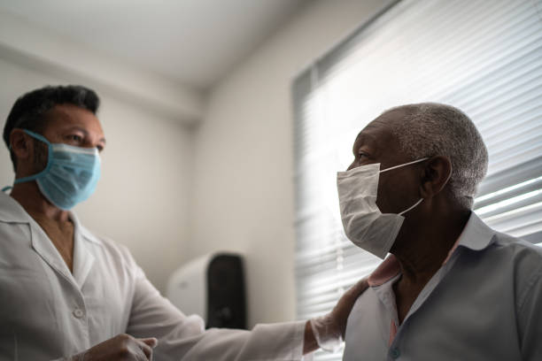 istock Doctor giving emotional support to a senior patient using face mask 1277116419
