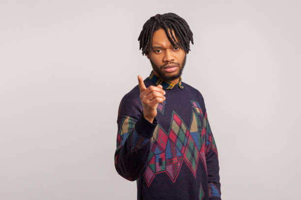 istock Strict serious african man with dreadlocks in casual sweatshirt pointing finger looking at camera, scolding and controlling, challenge 1277118440