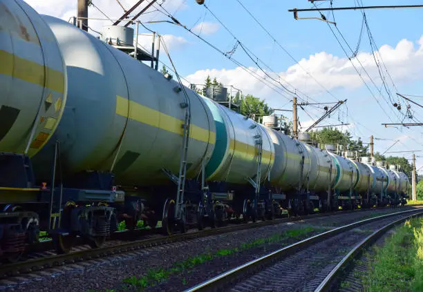Photo of Transport tank car LNG by rail, gas - oil products. LPG transport propane. The fuel train, rolling stock with petrochemical tank cars