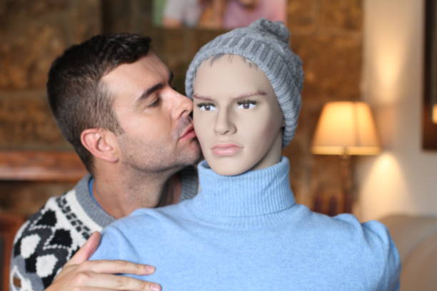 Handsome man kissing a mannequin Handsome man kissing a mannequin. blow up doll stock pictures, royalty-free photos & images