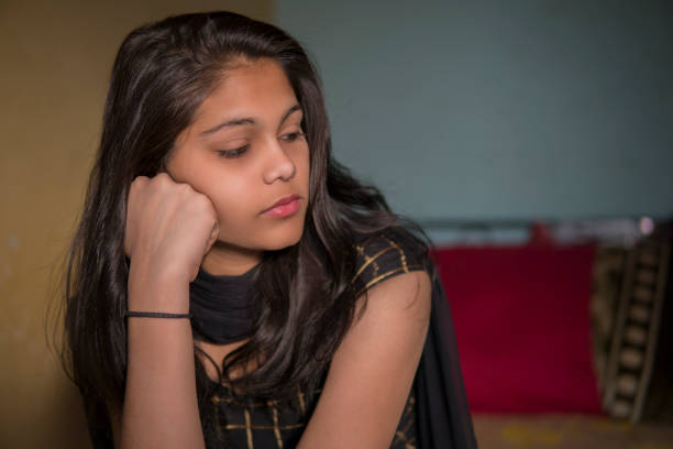 istock Portrait of sad, serene young girl thinking with blank expression 1277120575
