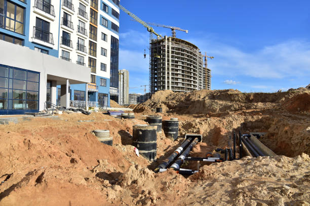 istock Laying heating pipes in a trench at construction site. Install underground storm systems of water main and sanitary sewer. 1277120651