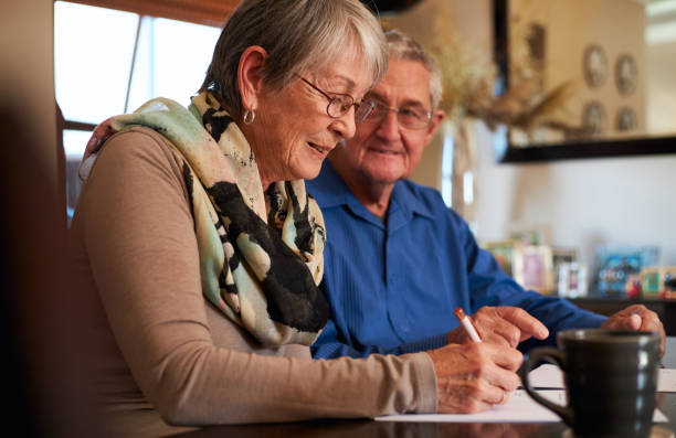 istock Senior Couple At Home Sitting At Table Checking Personal Finances 1277120658