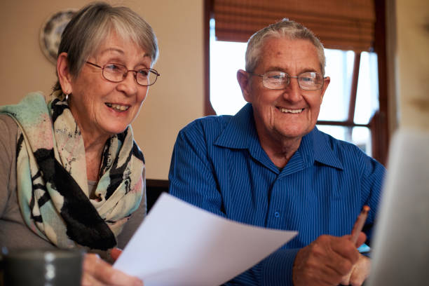 istock Smiling Senior Couple At Home Checking Personal Finances On Laptop 1277121189