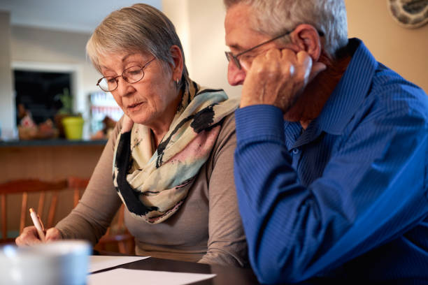 istock Senior Couple At Home Sitting At Table Checking Personal Finances 1277121298