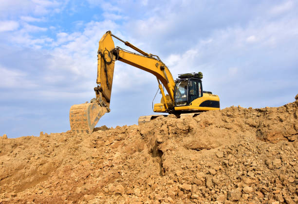 istock Excavator working on earthmoving at open pit mining. Backhoe digs gravel in quarry. 1277121360