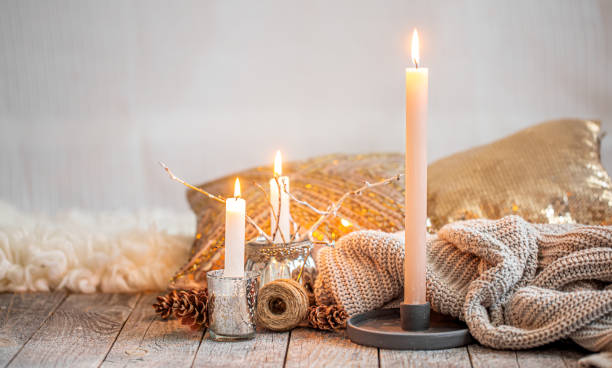 istock Cozy still life with burning candles and a knitted sweater. 1277125334