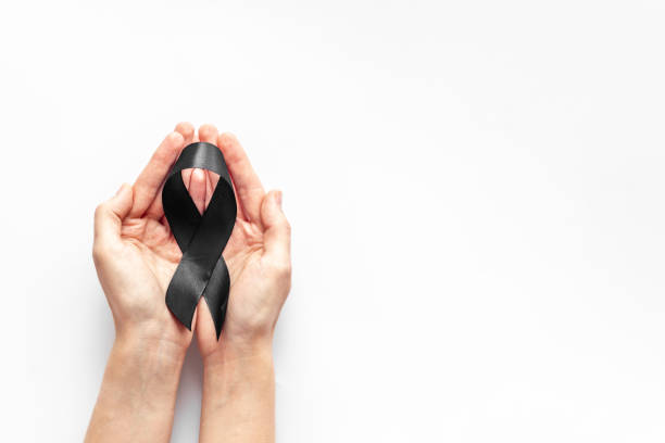 istock Hands holding black ribbon, top view. Funeral symbol 1277127215