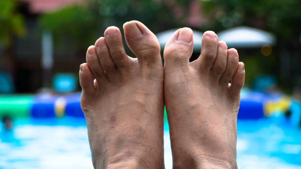 istock Man feet at swimming pool. 1277128185