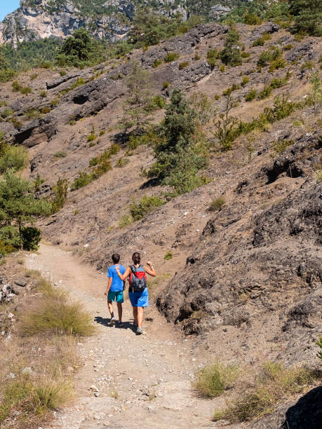 istock Young hikers enjoying summer vacation in countryside 1277132580