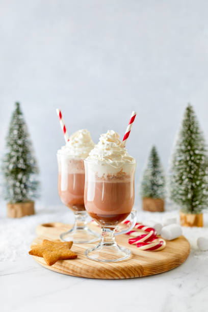 istock Hot chocolate or coffee with whipped cream  served with a candy cane, marshmallows, and gingerbread star 1277132818