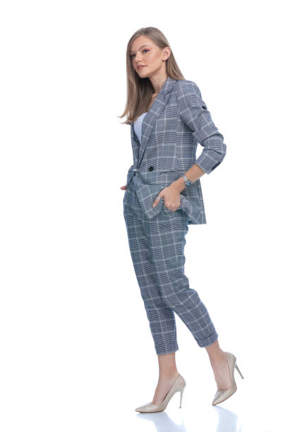 istock happy young woman holding hands in pockets 1277132864
