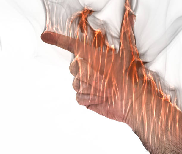 istock A human hand on fire burning with orange flames and some smoke in front of a bright background 1277136289