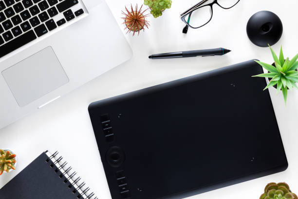 istock White office desk with graphic tablet and laptop. 1277136487