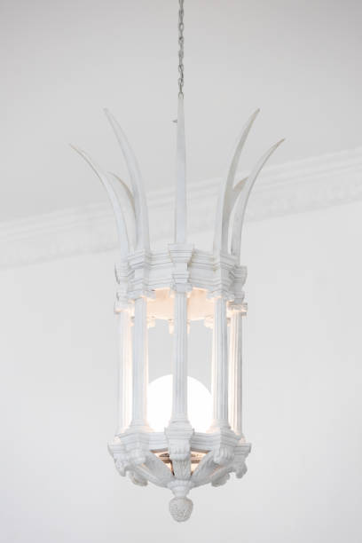 close up view of single white vintage stone lantern or lamp hanging from ceiling