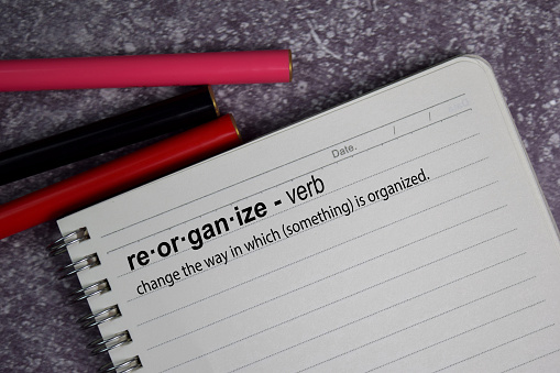 Definition of Reorganize word with a meaning on a book. dictionary concept