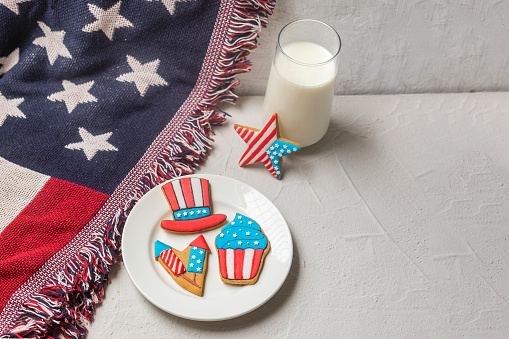 American flag cookies and glass of milk. Holiday sugar cookies on a flag. Patriotic cookies for 4th of July