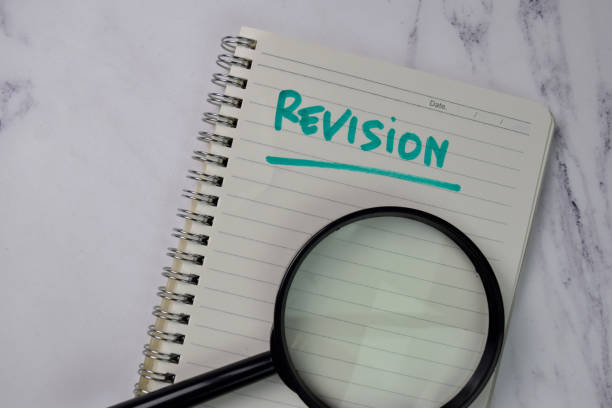 istock Revision write on a book isolated wooden table. 1277138854