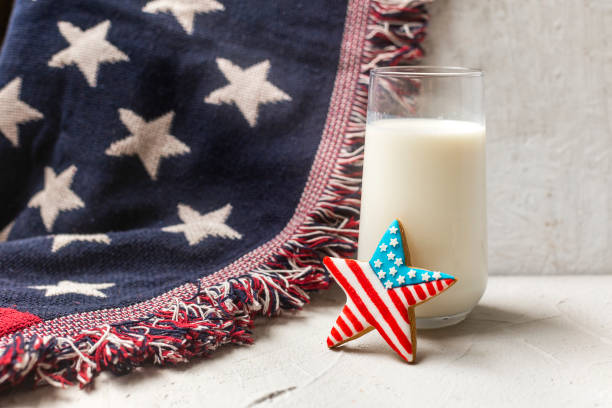 アメリカ国旗クッキーと牛乳のグラス。旗の上の休日の砂糖クッキー。7月4日の愛国的クッキー - 2599 ストックフォトと画像