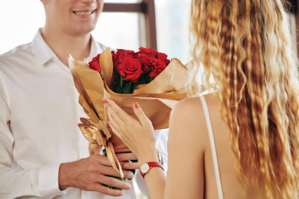 istock Man giving roses to girlfriend 1277139049
