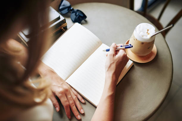 istock Creative woman filling journal 1277140043