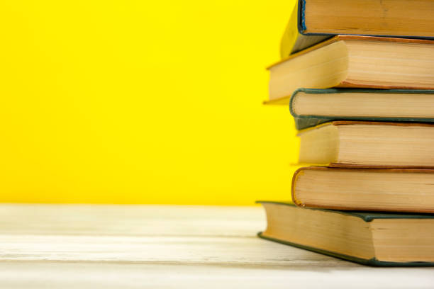 istock Open book, hardback books on wooden table. Back to school. Copy space. 1277141546
