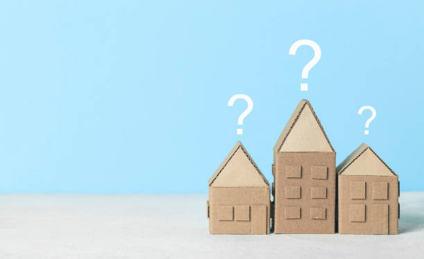 istock A question on a small house, a magnifying glass examines the building. Assistance in choosing and buying real estate 1277141599
