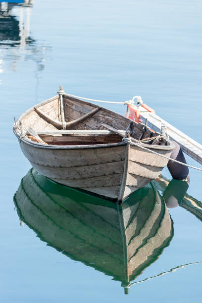 istock Old wooden boat mooring at the harbor 1277143130