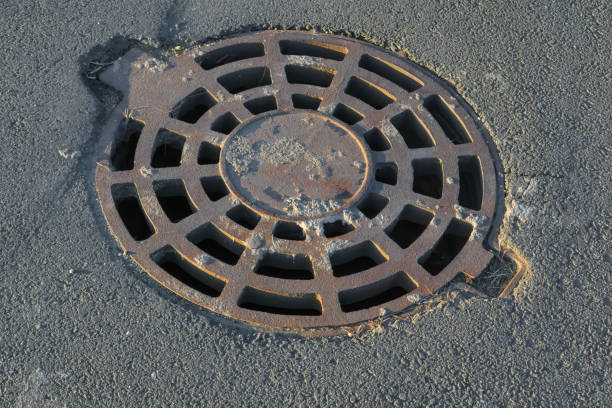 istock Cast-iron manhole cover storm sewer in the park 1277143894