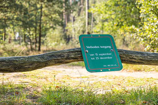 No Access sign at the entrance of the Kroondomein (Crown Domain) forest in the Veluwe nature reserve. The forest is closed so the royal family of The Netherlands can use the forest as hunting ground for shooting wild boar and deer. The maintenance of the forest is heavily subsidised and therefor the closure to the public is criticized.