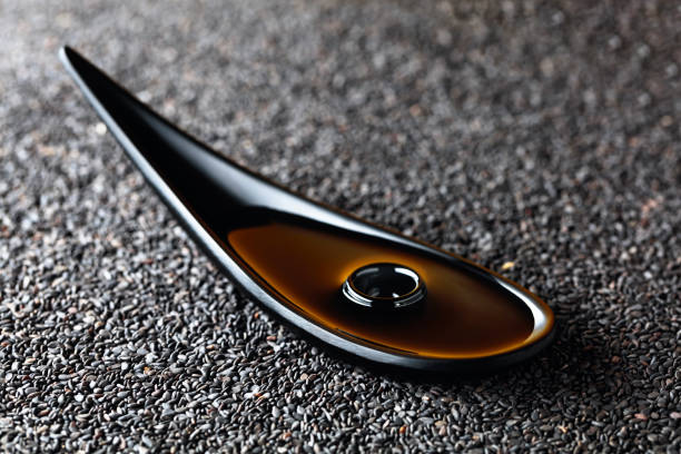 istock Sesame oil and raw black sesame seeds. 1277145626