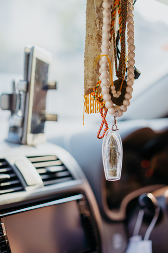 Thai Buddha amulet hanging in car as good luck charm blessing for a safe journey