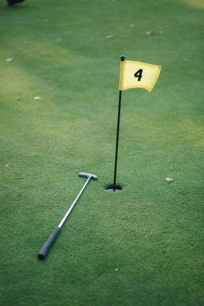 istock Beautiful green field golf grass and hole with flag 1277148175